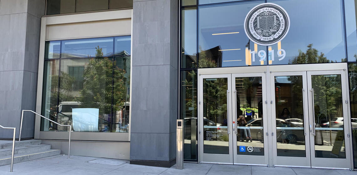 The west entrance to Berkeley Way West. To the left of the doors is an automatic door opener.